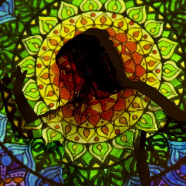 Woman in a flowing yoga stretch against a lime accent background.